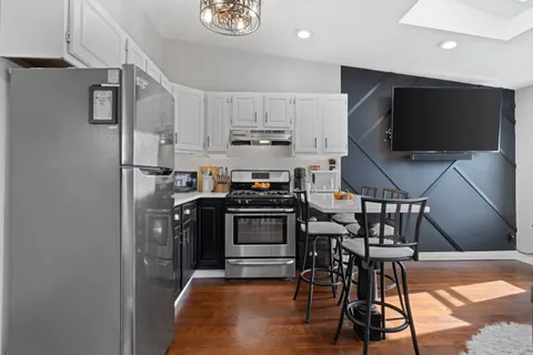 a kitchen with stainless steel appliances granite countertop a stove and a refrigerator