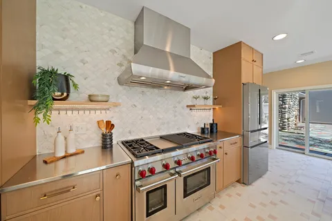 a view of a dining room with furniture wooden floor and a floor to ceiling window