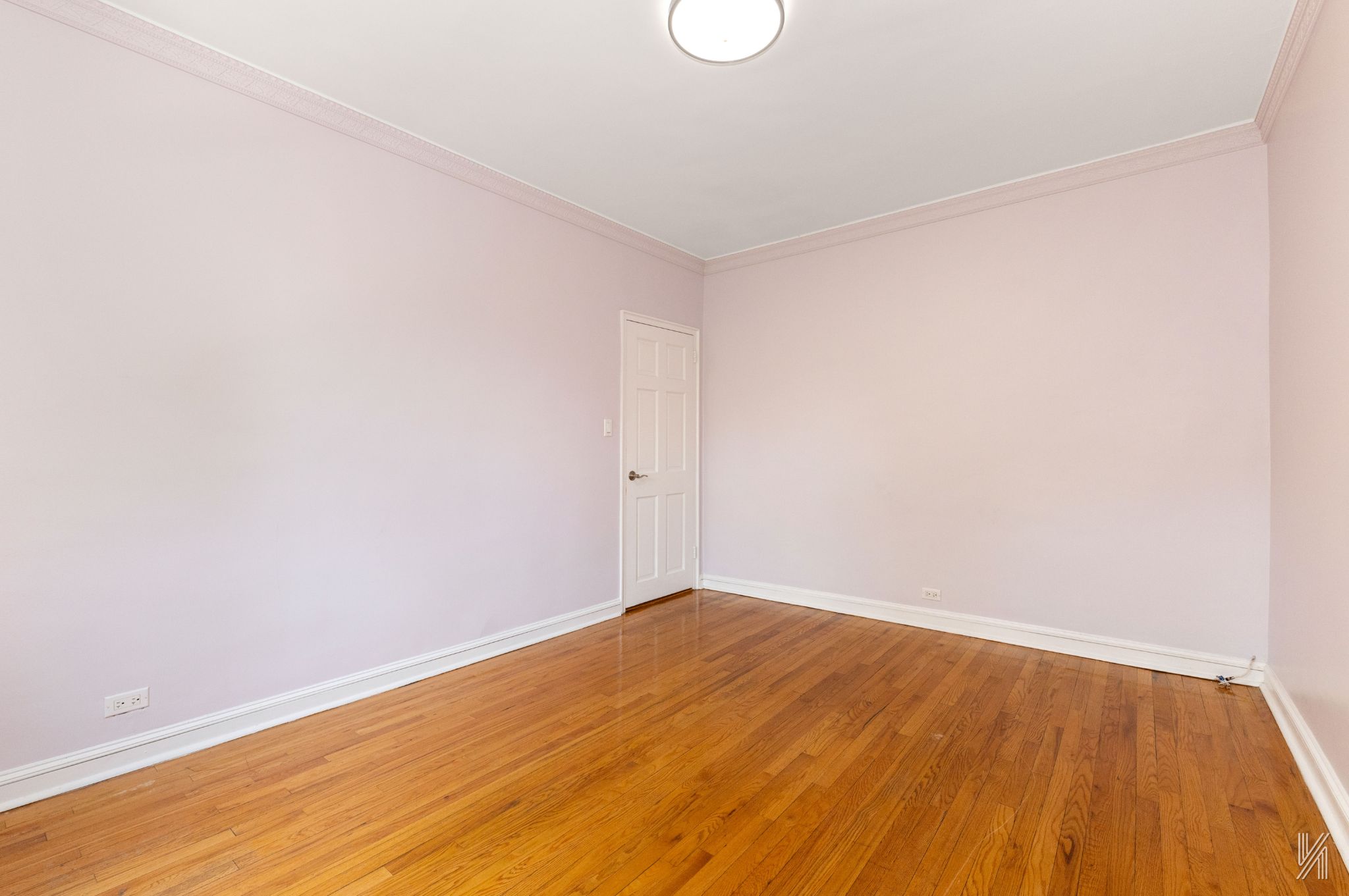 22-20 76th Street, Unit C3 Queens, NY 11370 - Photo 15 of 20 a view of empty room with wooden floor