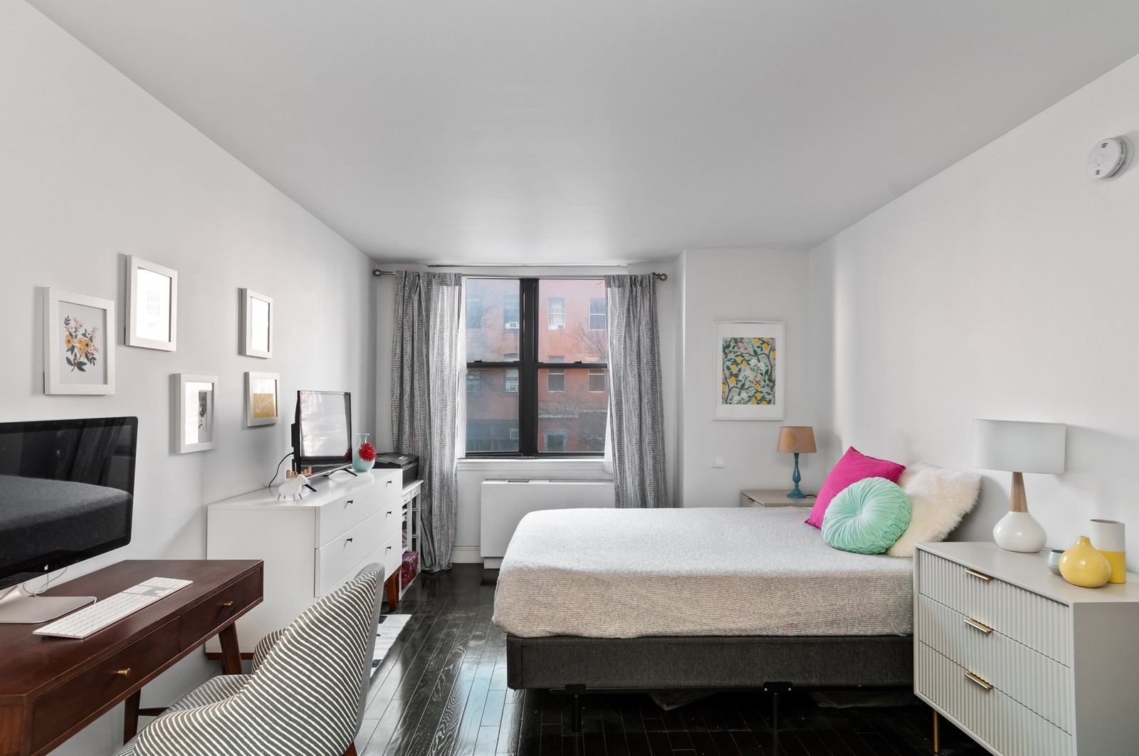 222 West 14th Street, Unit 2M Manhattan, NY 10011 - Photo 1 of 9 a bedroom with a bed and a couch