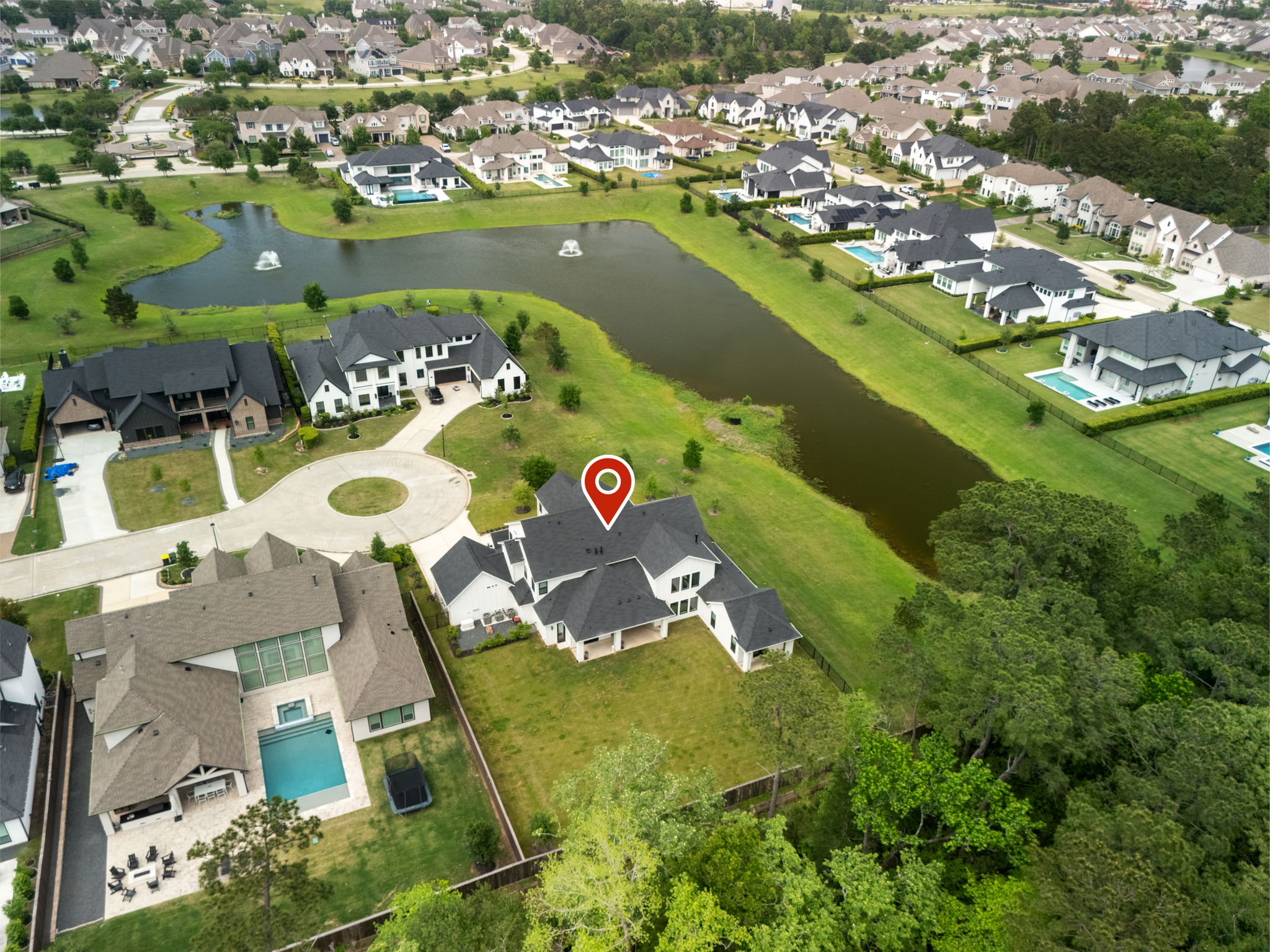 2118 Bennet Court Conroe, TX 77384 - Photo 6 of 70 an aerial view of a house with a swimming pool yard and lake view