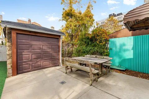 a backyard of a house with barbeque oven and outdoor seating