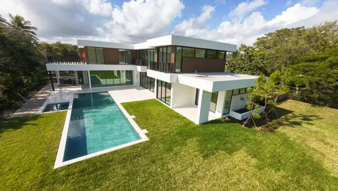 a view of a patio with table and chairs under an umbrella