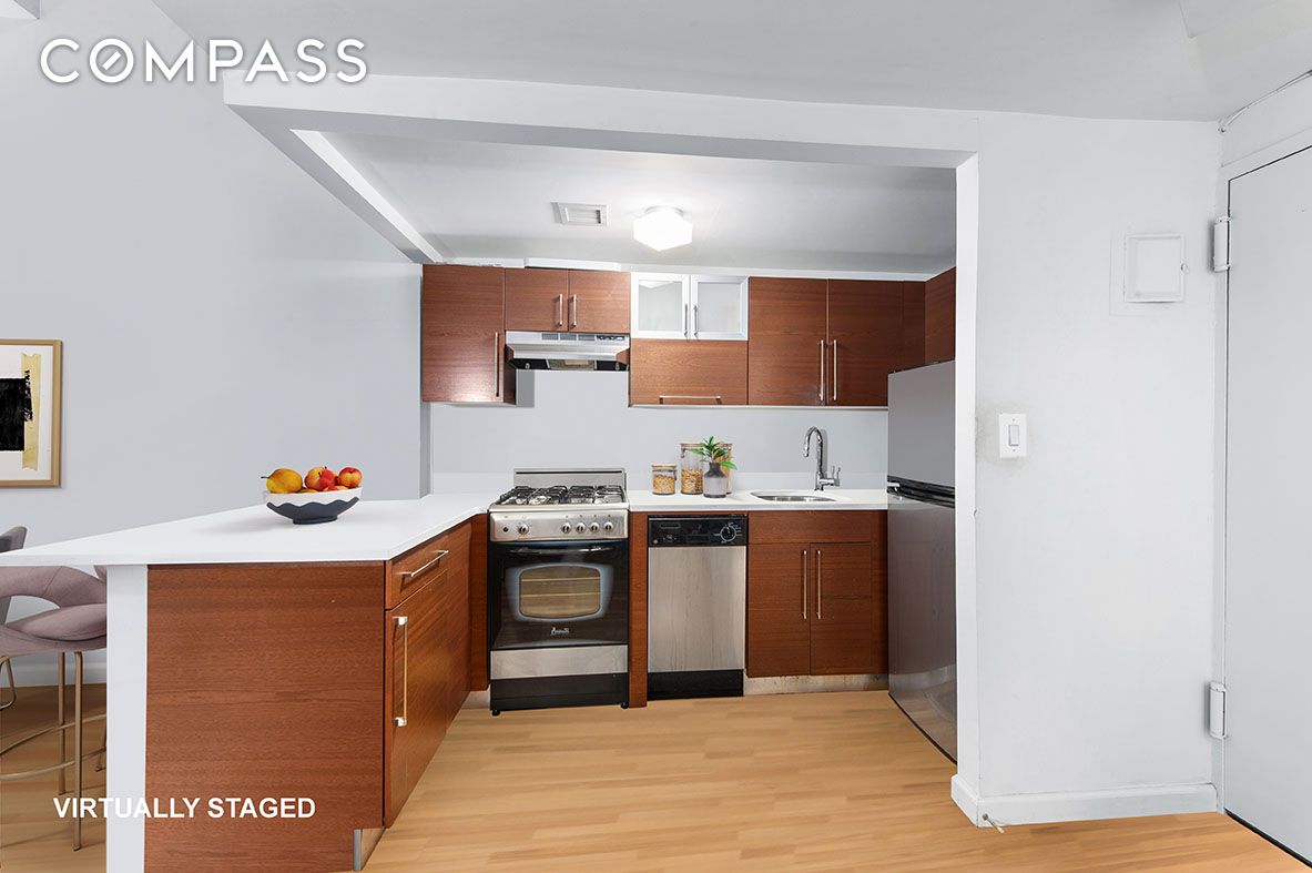 184 Thompson Street, Unit 1E Manhattan, NY 10012 - Photo 3 of 8 a kitchen with a sink a stove and refrigerator