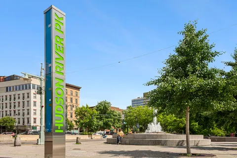 a front view of a building with a garden