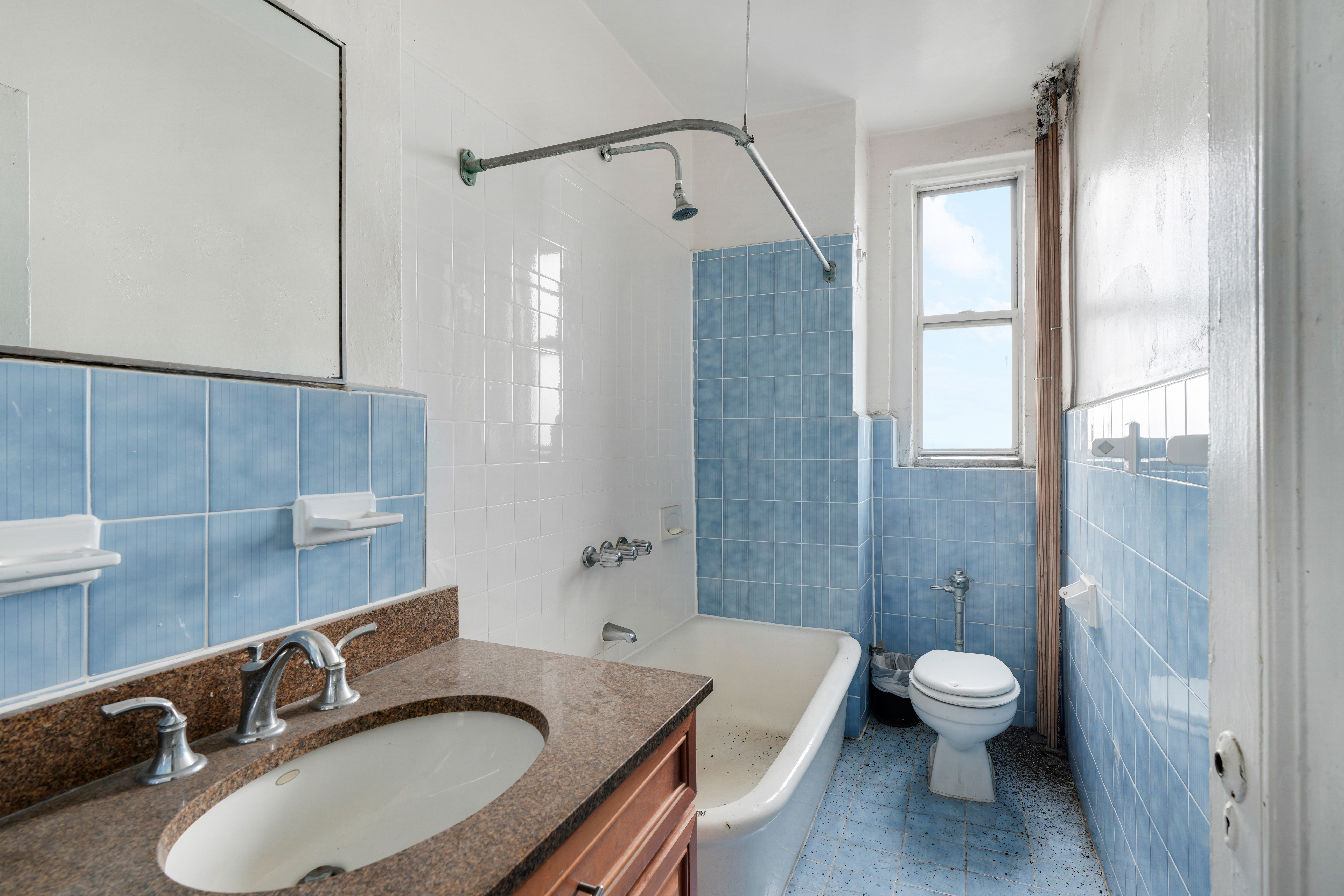 416 Ocean Avenue, Unit 62 Brooklyn, NY 11226 - Photo 13 of 22 a bathroom with a granite countertop sink toilet a mirror and shower