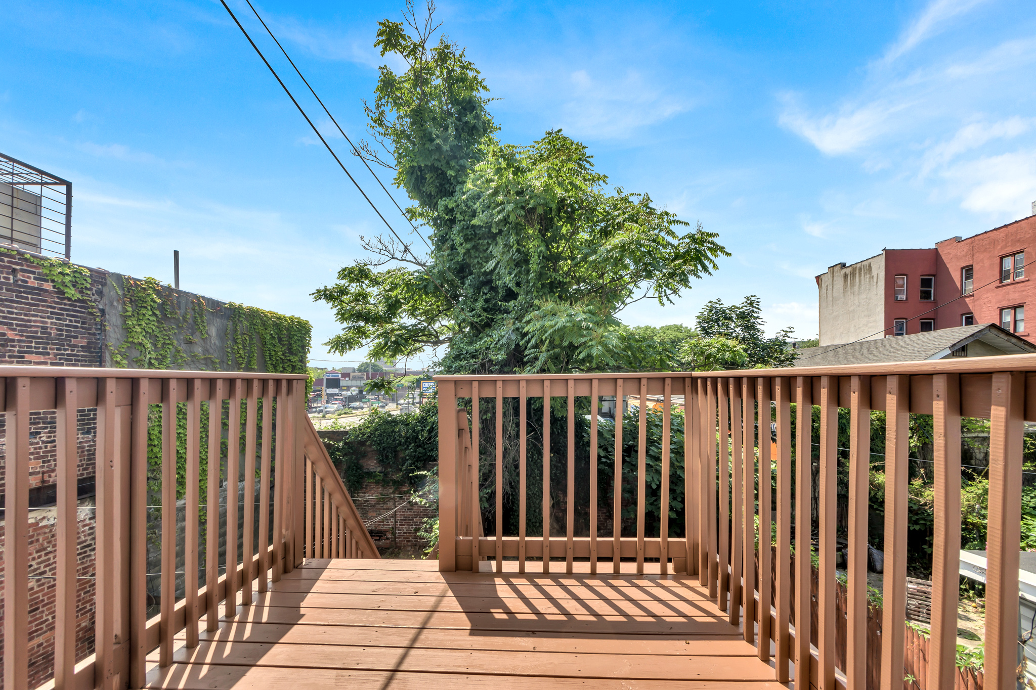 28 Roosevelt Place, Unit 2 Brooklyn, NY 11233 - Photo 4 of 12 a view of balcony with wooden floor and fence