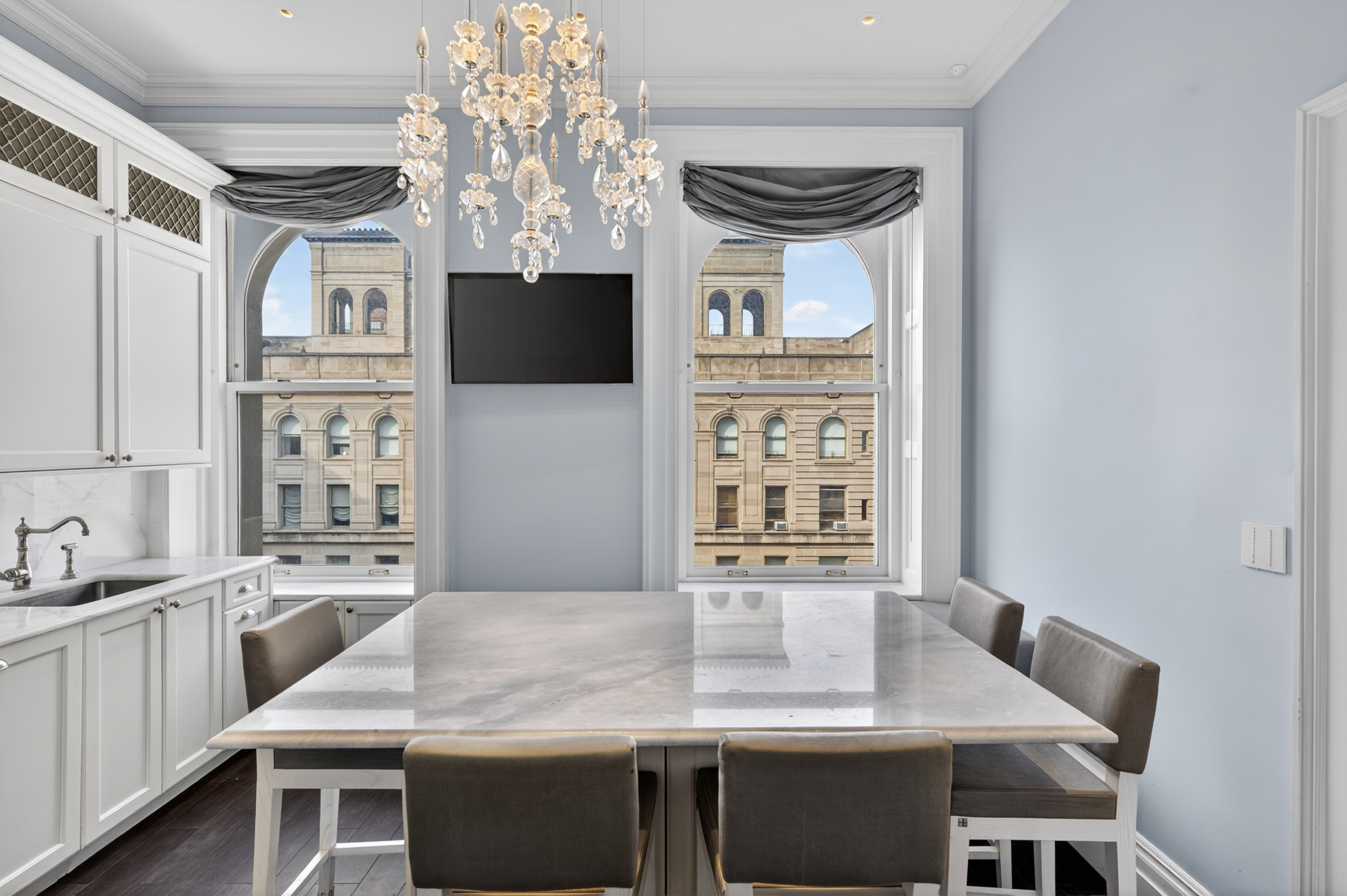 390 West End Avenue, Unit 11C Manhattan, NY 10024 - Photo 6 of 24 a kitchen with a table chairs and microwave