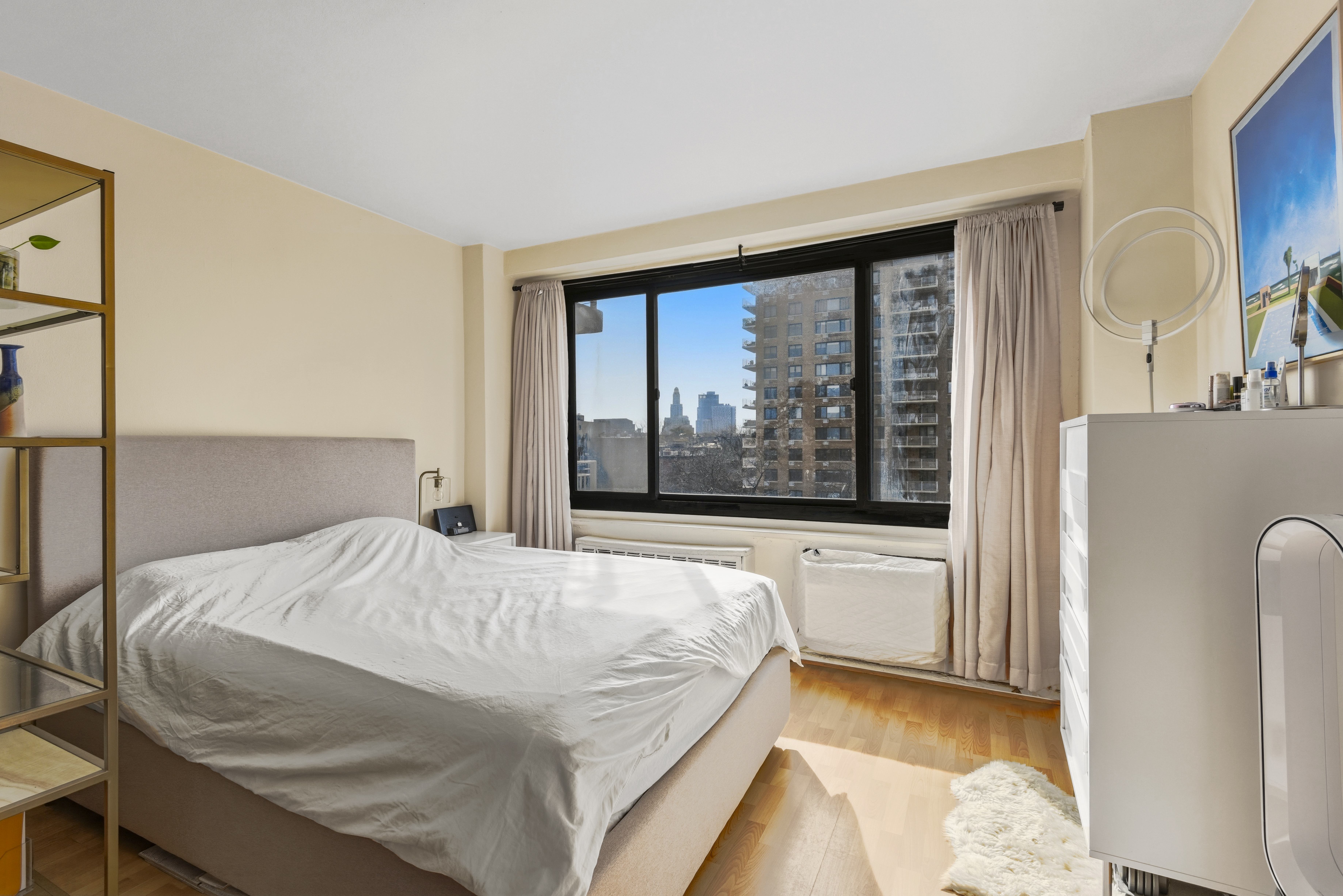 195 Willoughby Avenue, Unit 702 Brooklyn, NY 11205 - Photo 7 of 11 a bedroom with a bed and a large window with outer view