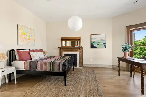 a bedroom with furniture and a wooden floor