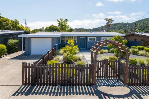 a view of a house with wooden fence