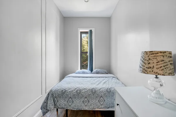 a bedroom with a bed and a window