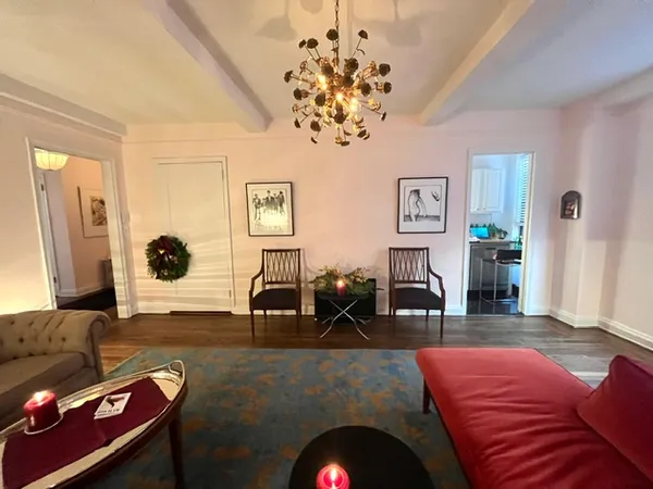 a living room with furniture and a chandelier