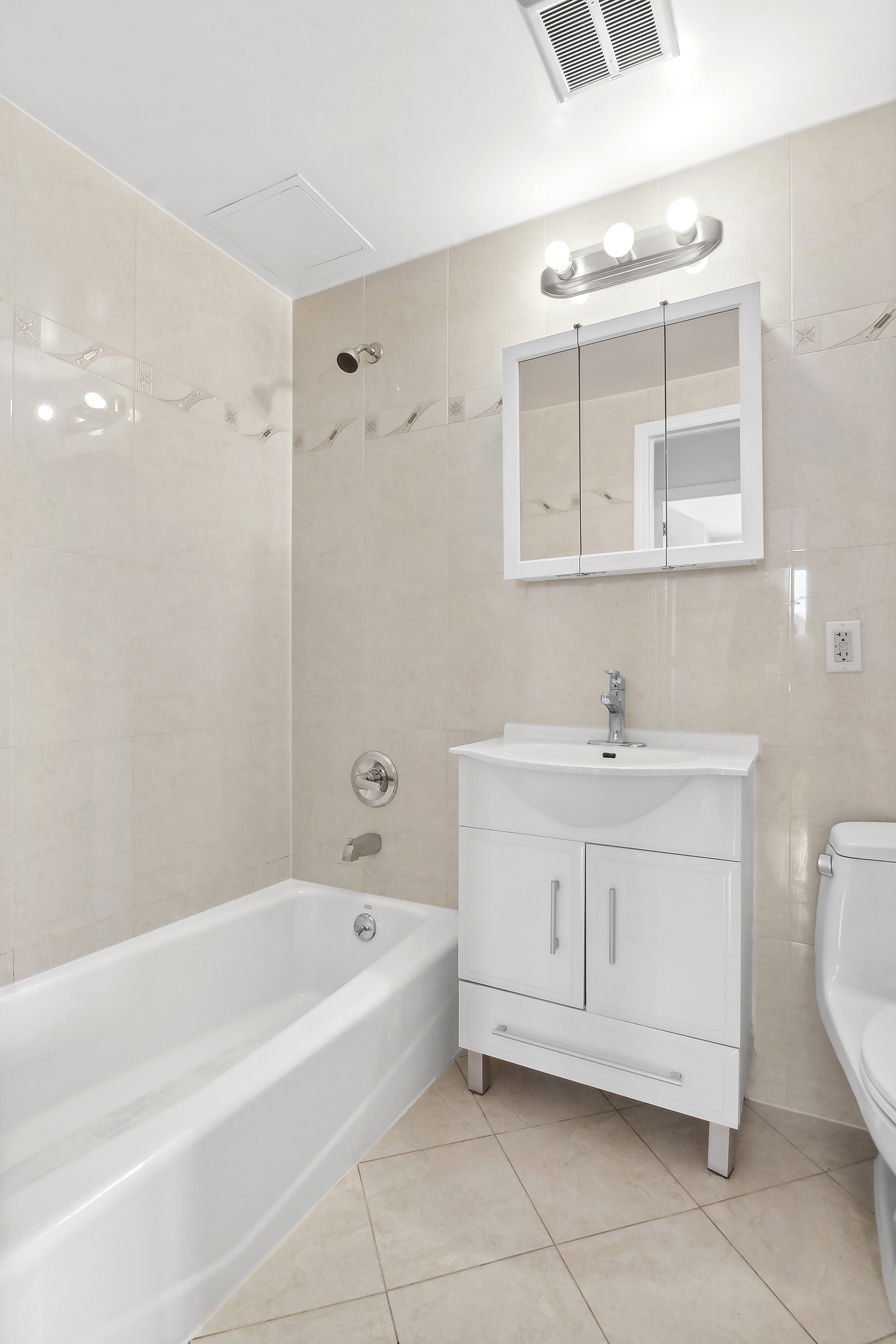 63-14 Queens Boulevard, Unit 7P Queens, NY 11377 - Photo 7 of 10 a bathroom with a bathtub a sink a mirror a vanity and a shower