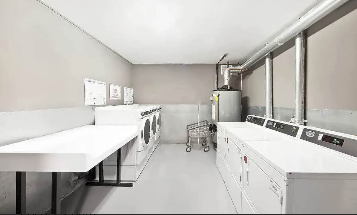 44 Berry Street, Unit 6B Brooklyn, NY 11249 - Photo 8 of 9 a room with a bed a table and chairs