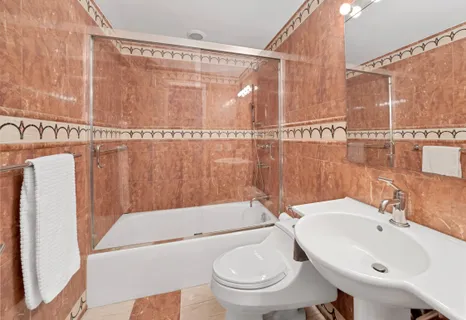 a bathroom with a sink toilet and shower