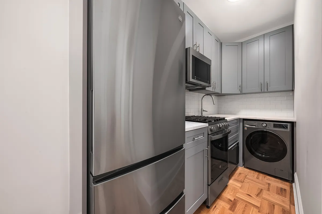 130 West 80th Street, Unit 5R Manhattan, NY 10024 - Photo 5 of 7 a kitchen with a stove top oven and refrigerator