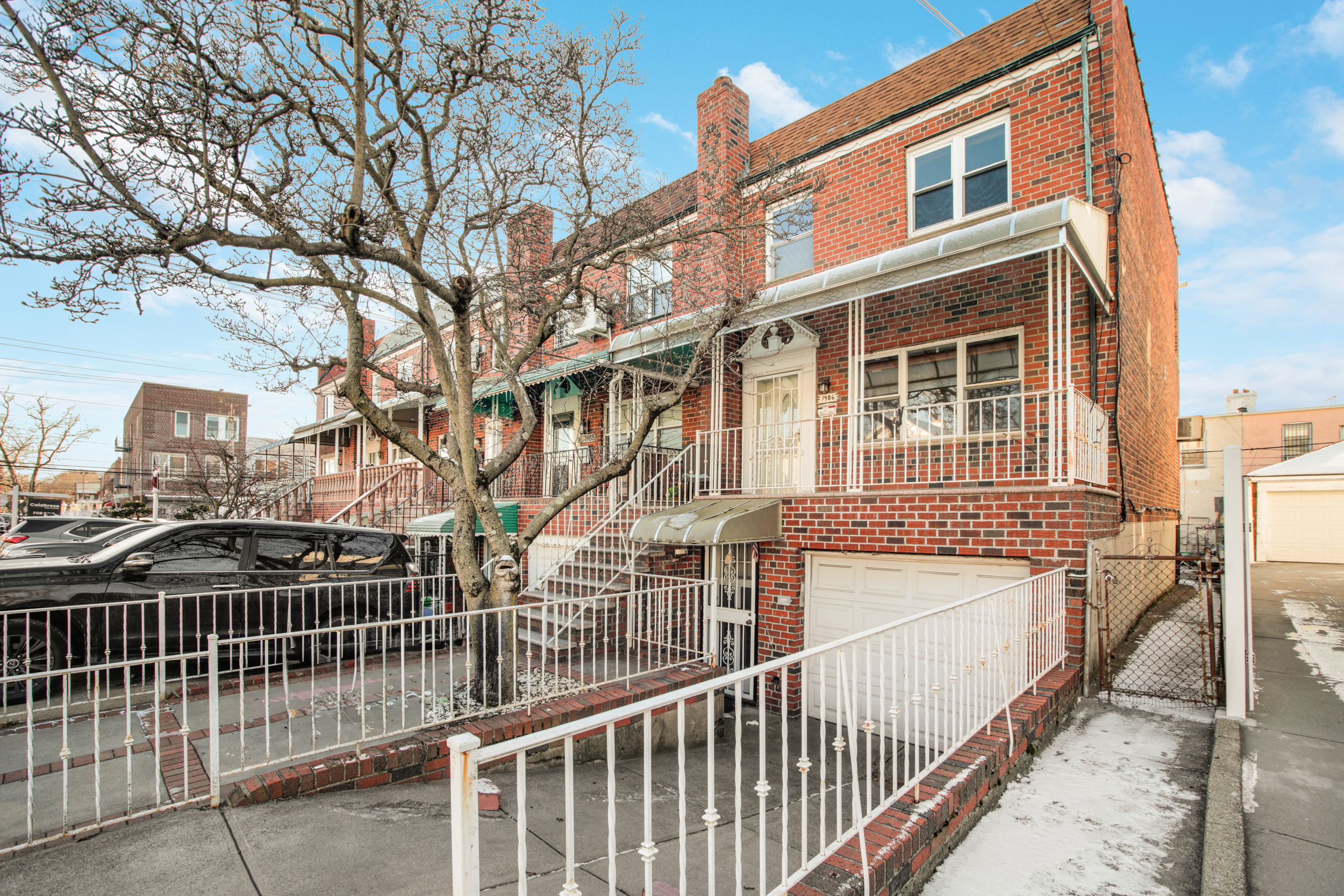1986 West 13th Street Brooklyn, NY 11223 - Photo 10 of 11 a view of a brick house with large trees