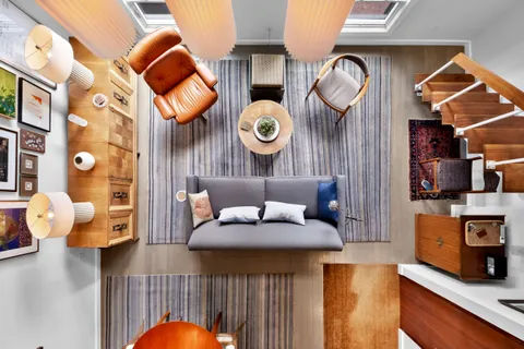 a kitchen with stainless steel appliances granite countertop a table chairs sink and cabinet