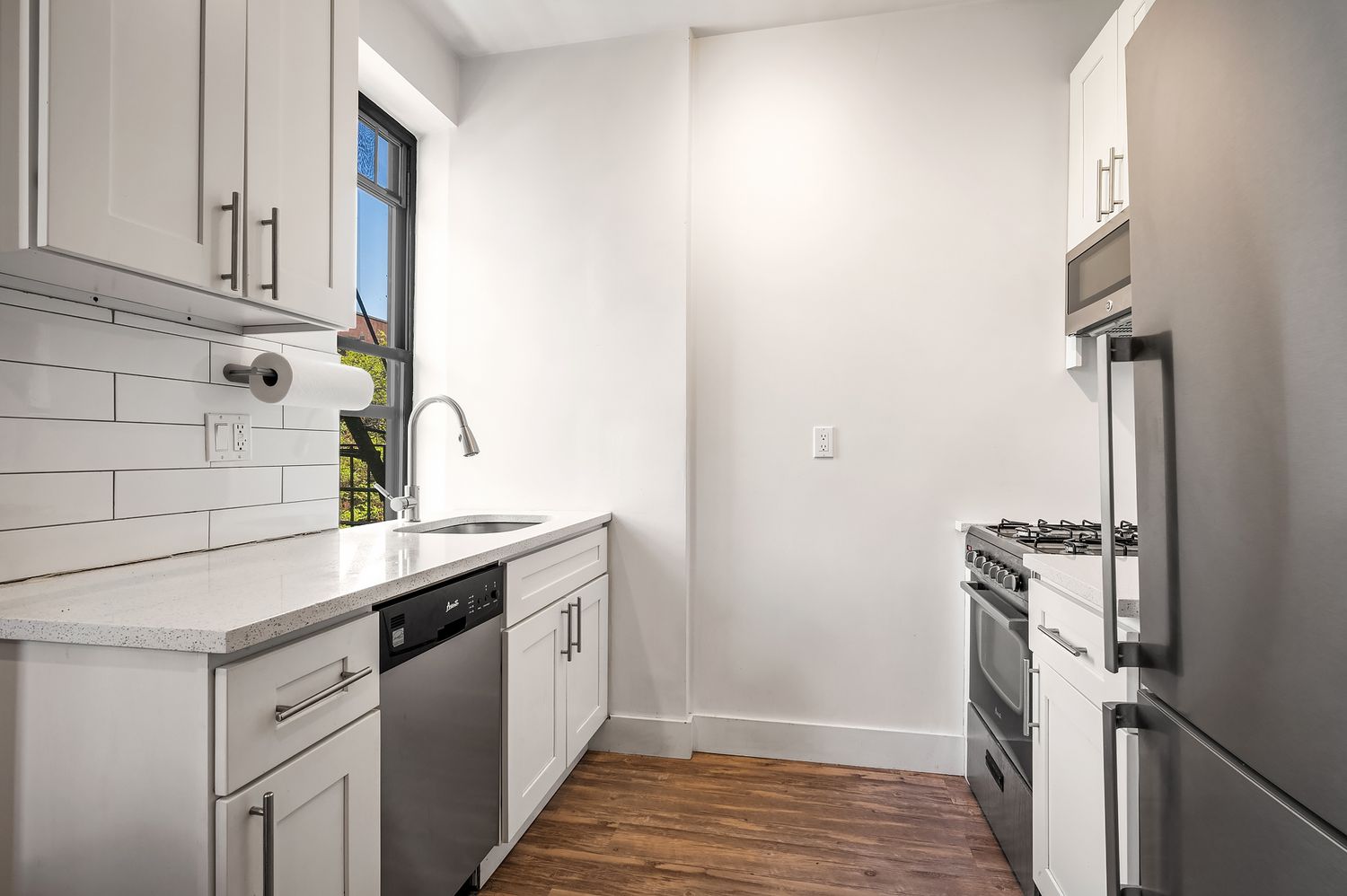 164 West 128th Street, Unit 2A Manhattan, NY 10027 - Photo 1 of 4 a kitchen with stainless steel appliances granite countertop a stove and a refrigerator