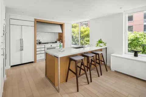 a view of a dining room with furniture and a window