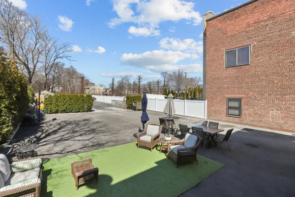 a view of a patio with couches and a table and chairs