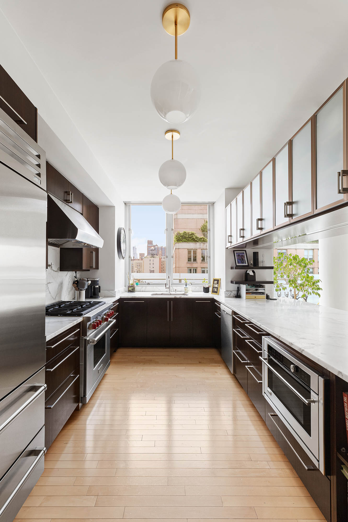 545 West 110th Street, Unit PH11A Manhattan, NY 10025 - Photo 5 of 22 a kitchen with stainless steel appliances a stove sink and cabinets