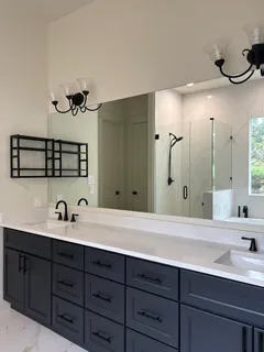 a bathroom with a double vanity sink and mirror