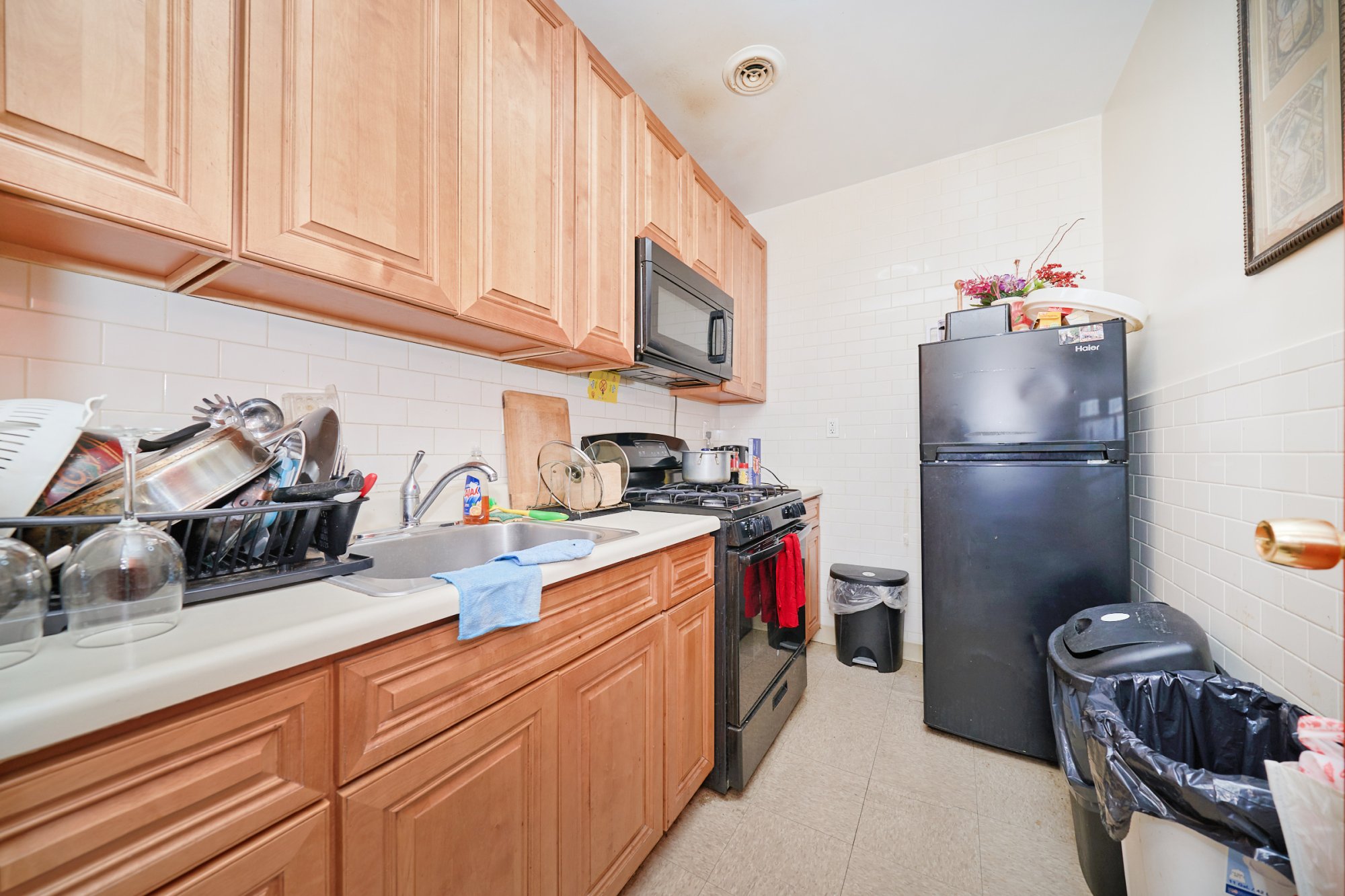 197 Edgecombe Avenue Manhattan, NY 10030 - Photo 3 of 12 a kitchen with refrigerator and cabinets