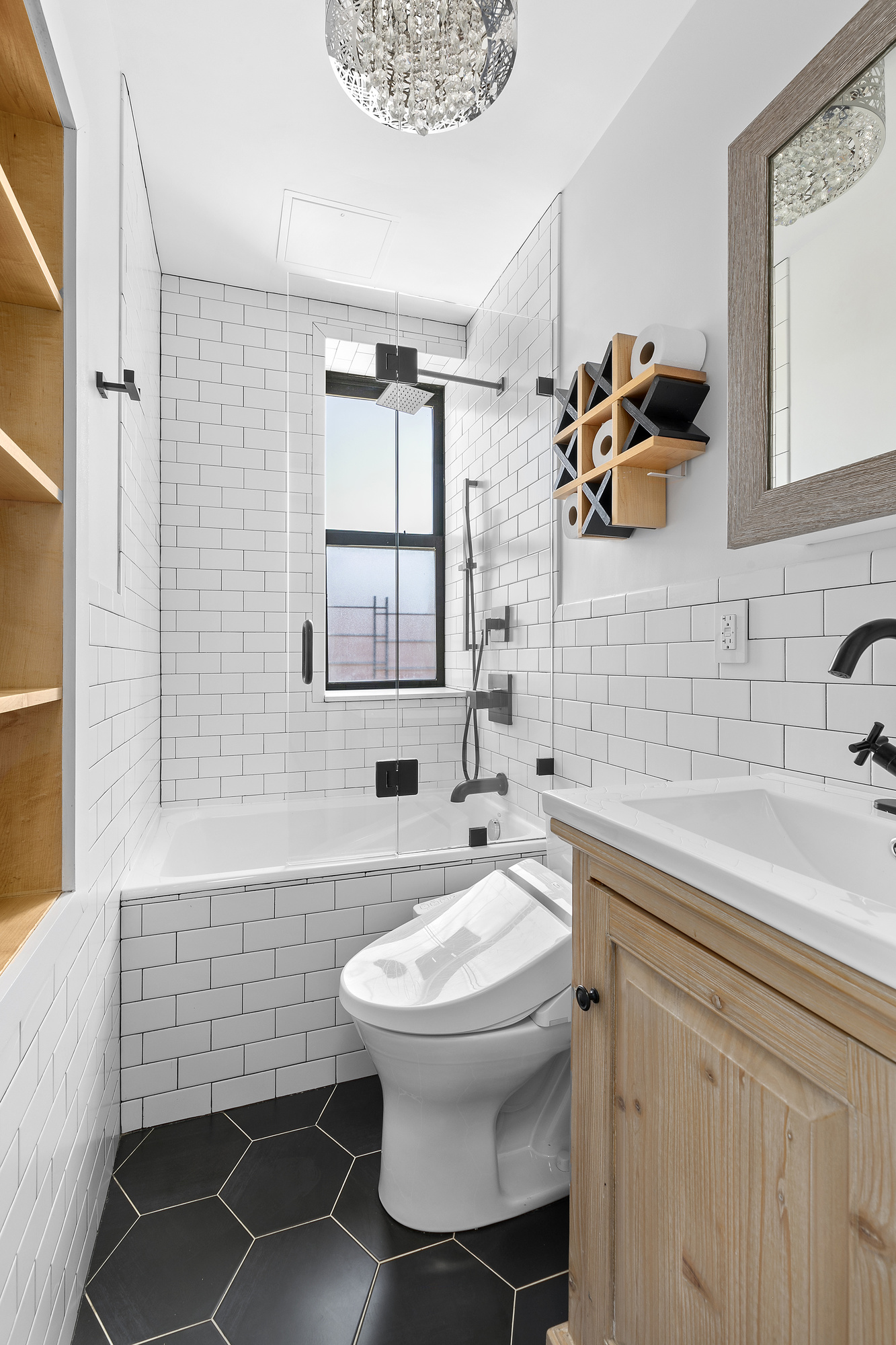 108 Division Avenue, Unit 22 Brooklyn, NY 11211 - Photo 5 of 11 a bathroom with a sink toilet a mirror and shower
