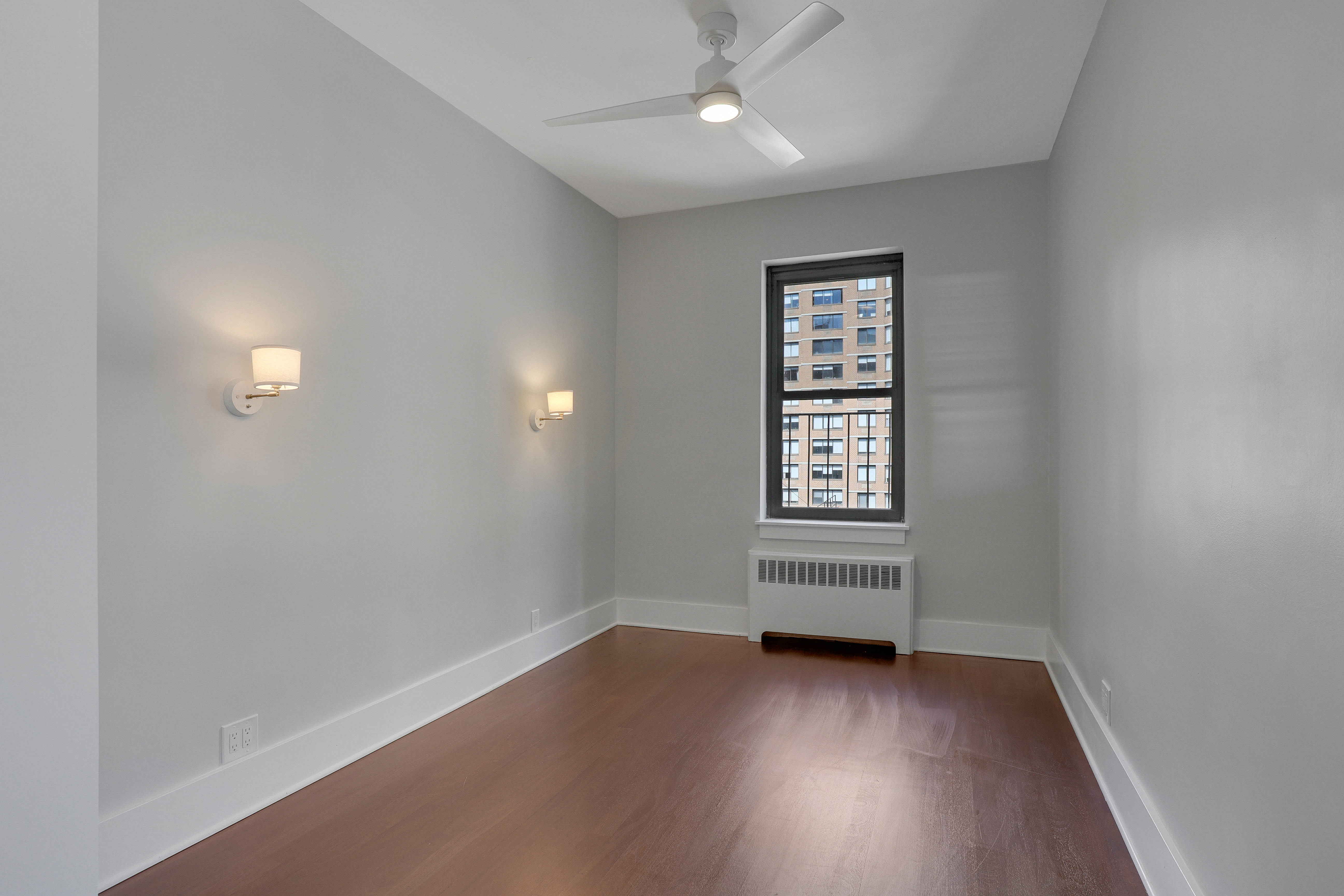 133 East 30th Street, Unit PH5B Manhattan, NY 10016 - Photo 12 of 24 an empty room with wooden floor and windows