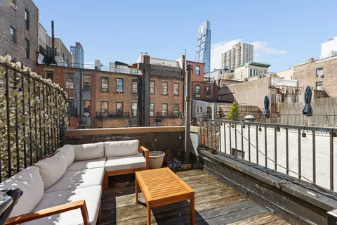 a view of a balcony with two chairs