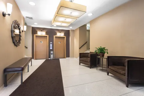 a lobby with furniture and wooden floor