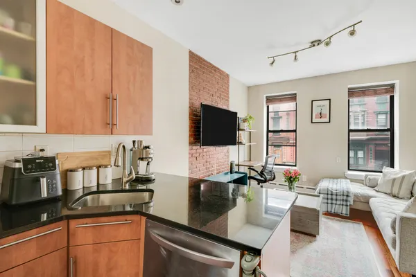 a kitchen with granite countertop a sink and a stove top oven