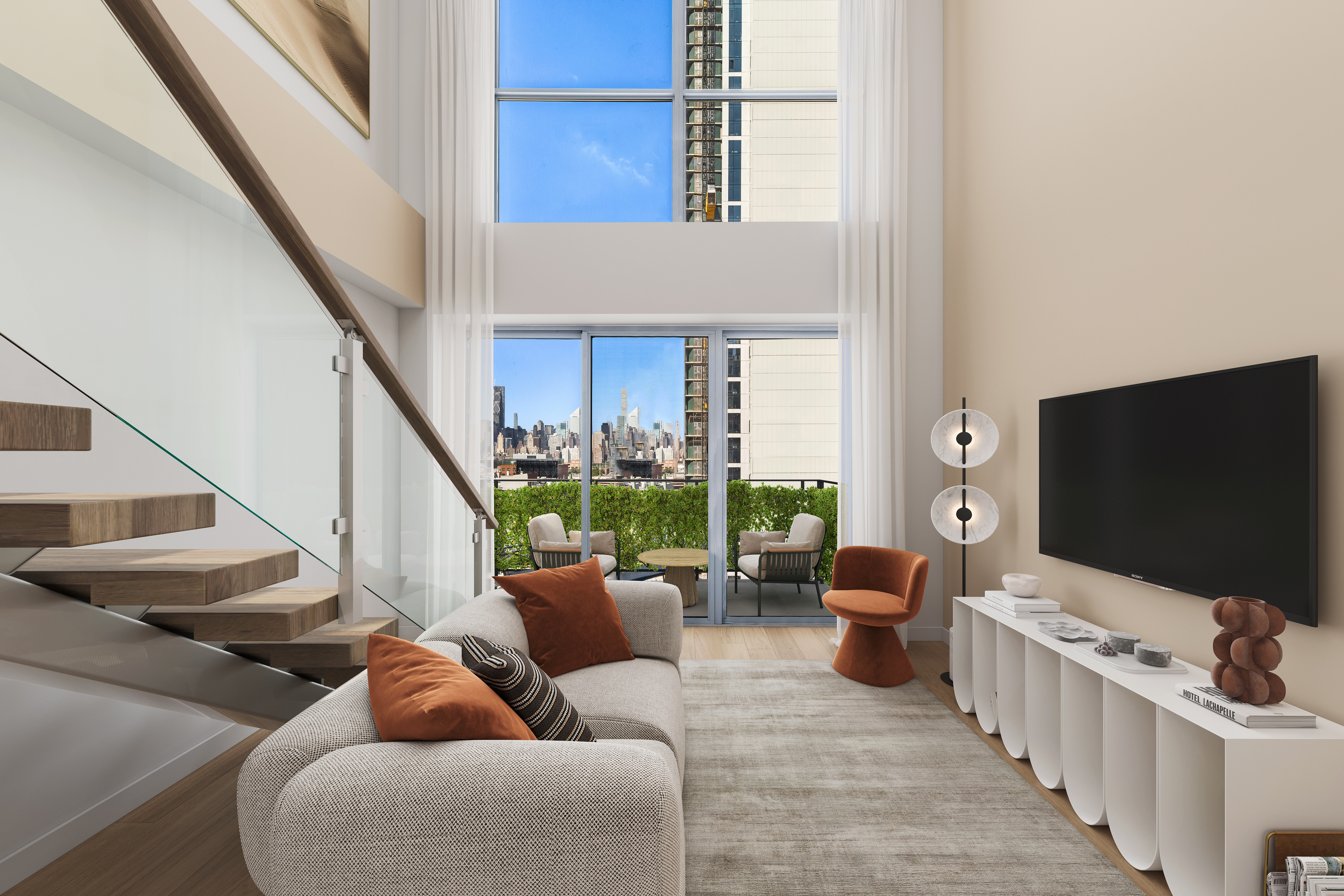 42-44 Crescent Street, Unit PHB Queens, NY 11101 - Photo 3 of 11 a living room with furniture and a flat screen tv