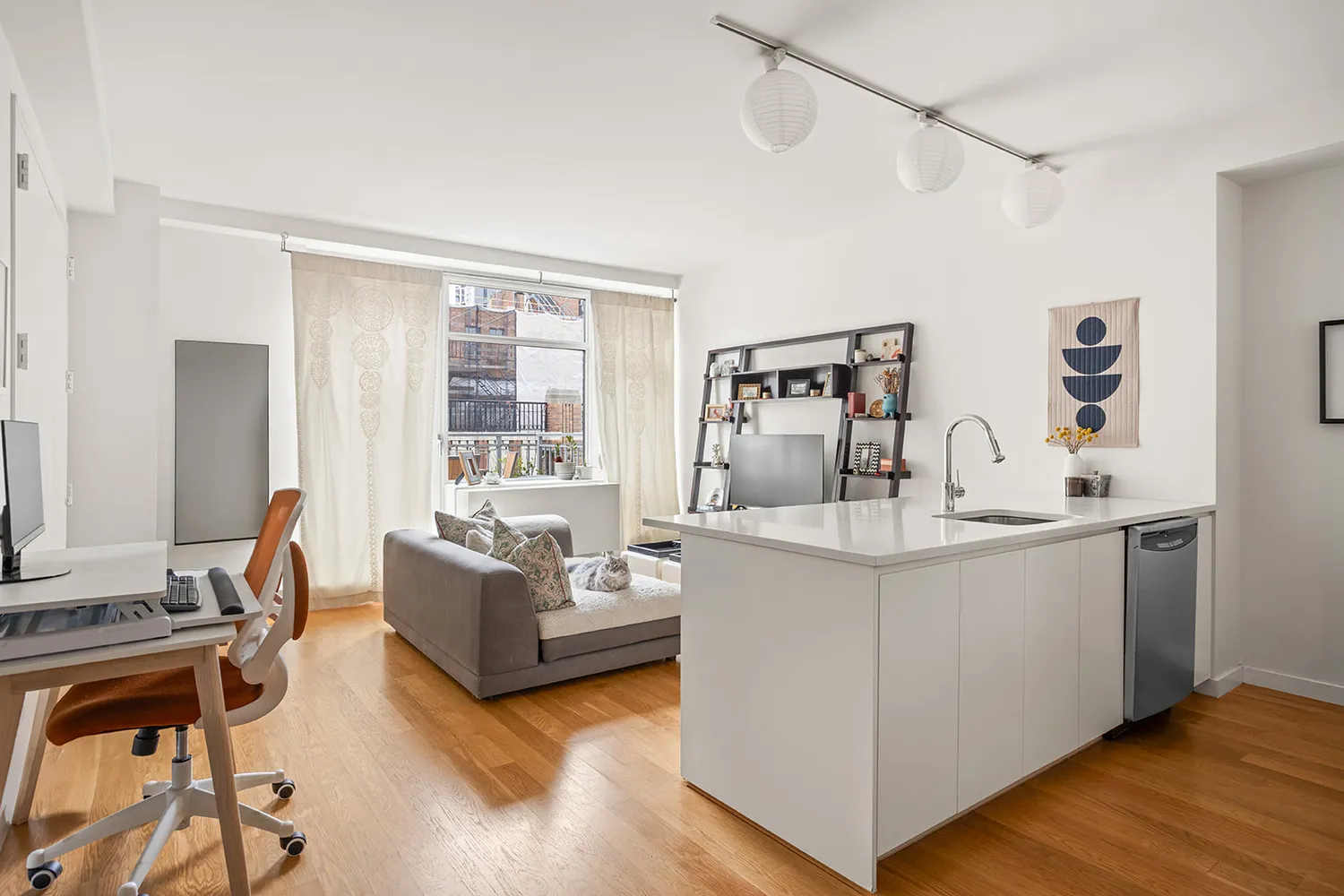a living room with furniture and large windows
