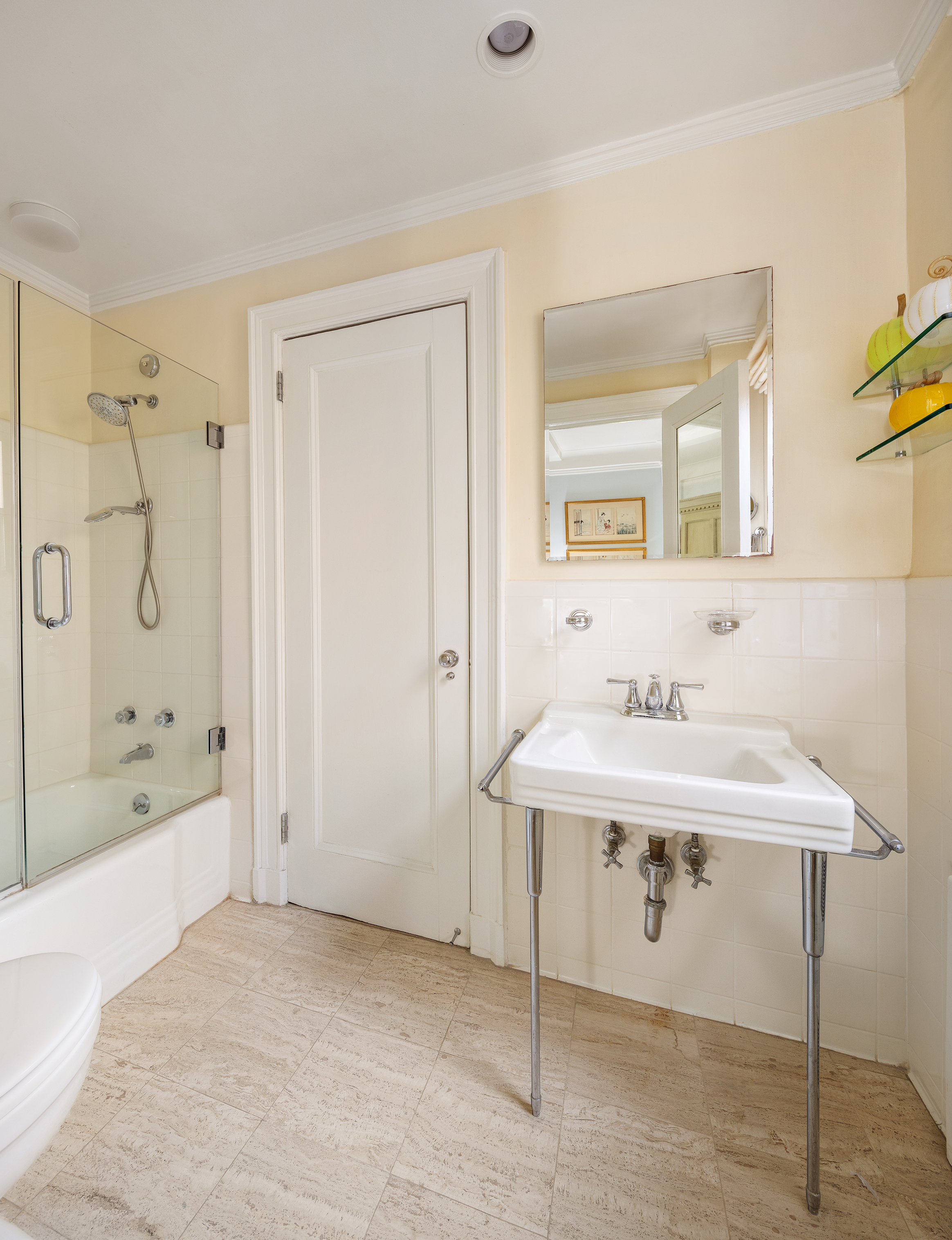 70 East 77th Street, Unit 6A Manhattan, NY 10075 - Photo 13 of 17 a bathroom with a sink a mirror and a bathtub