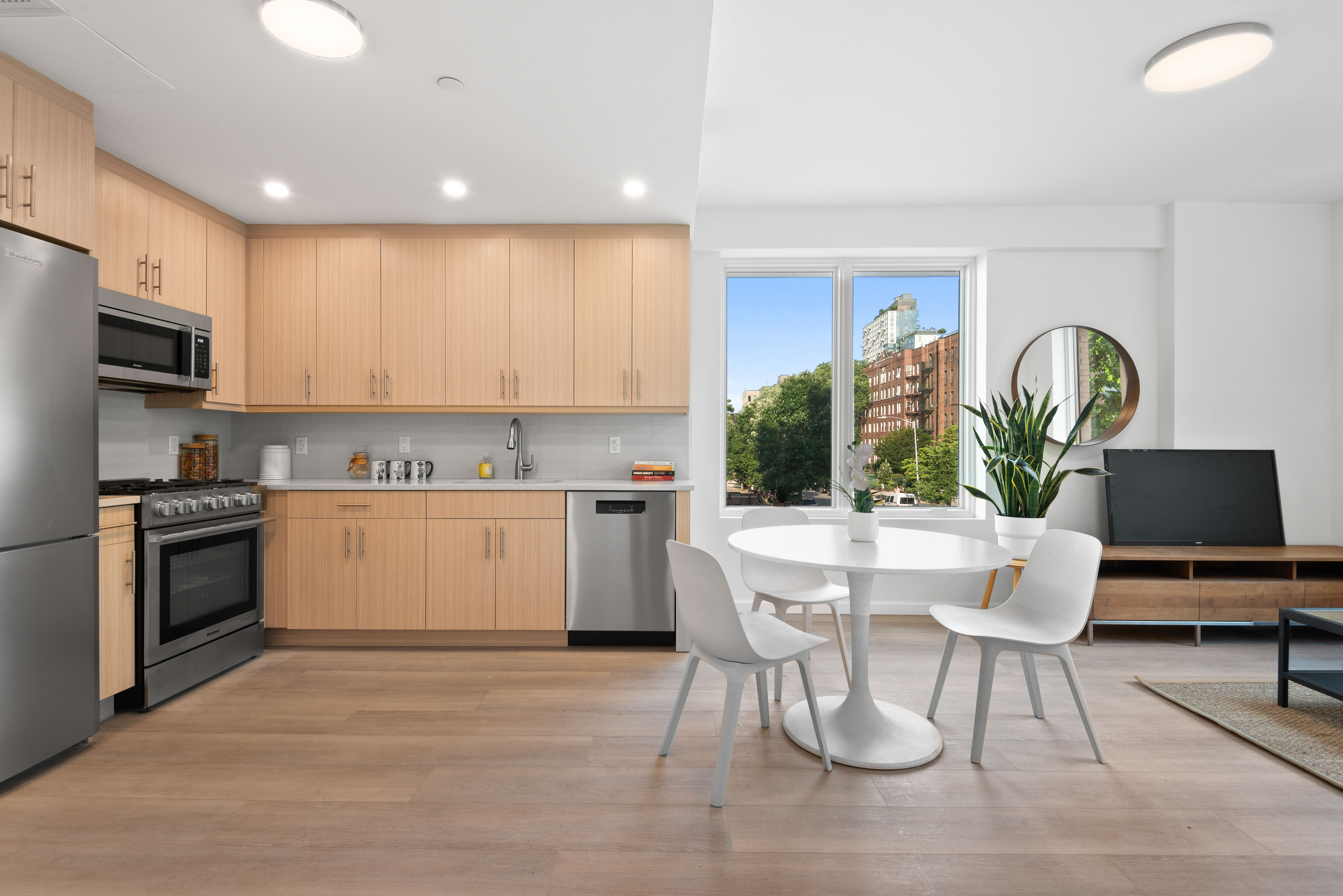1 Lenox Road, Unit 5A Brooklyn, NY 11226 - Photo 2 of 10 a kitchen with a table chairs microwave and cabinets