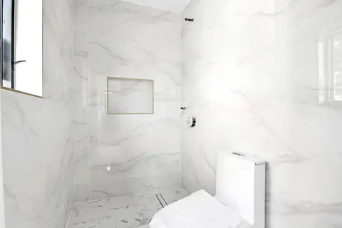 a bathroom with a toilet and shower