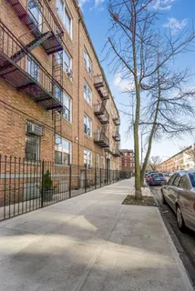 a view of a street with a car parked on the road