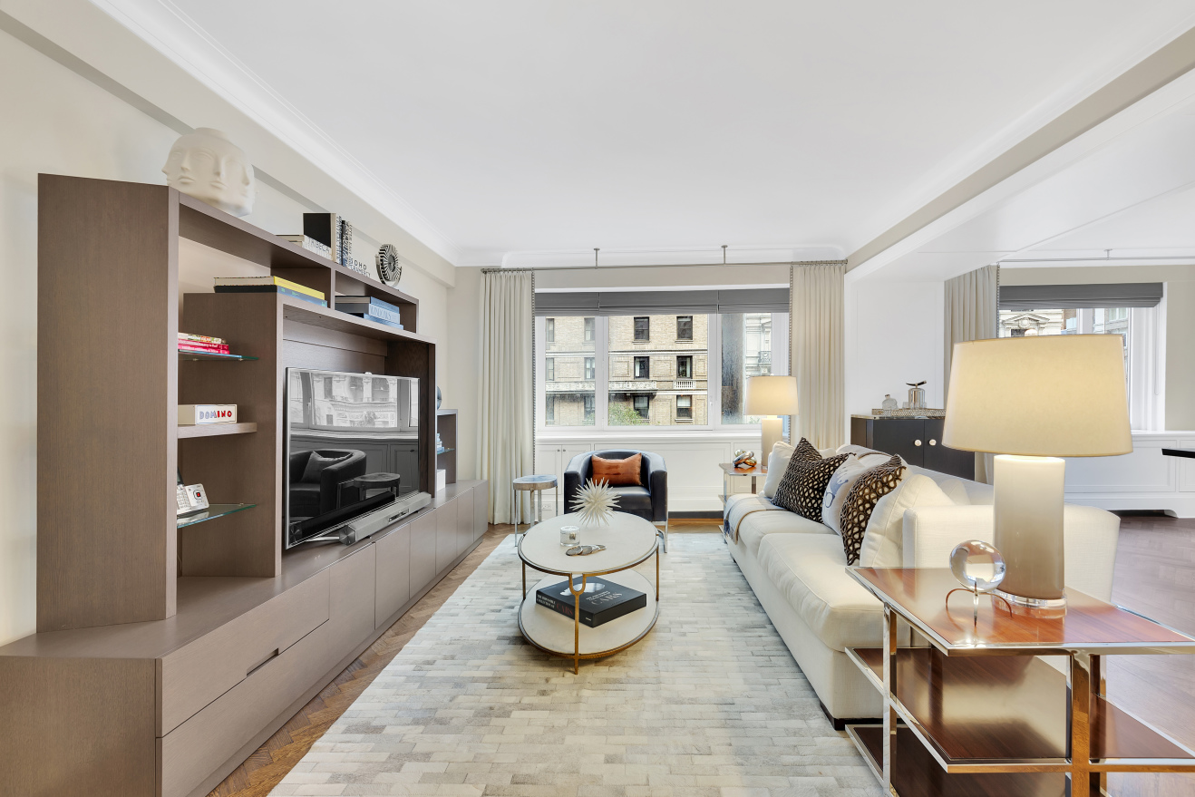 530 Park Avenue, Unit 4A Manhattan, NY 10065 - Photo 2 of 16 a living room with furniture and a flat screen tv