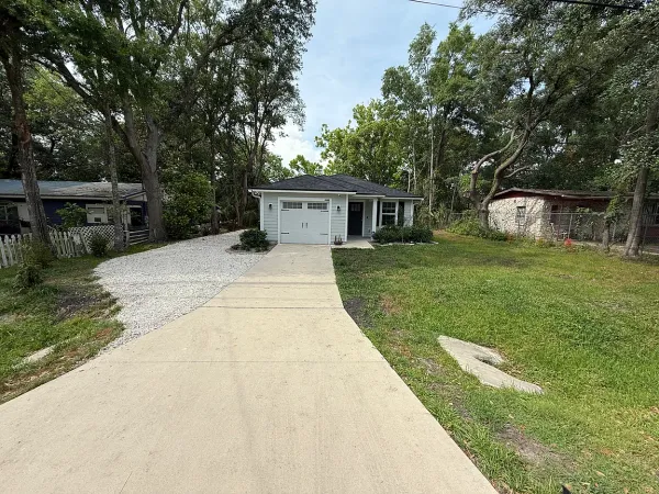 a front view of house with yard and trees