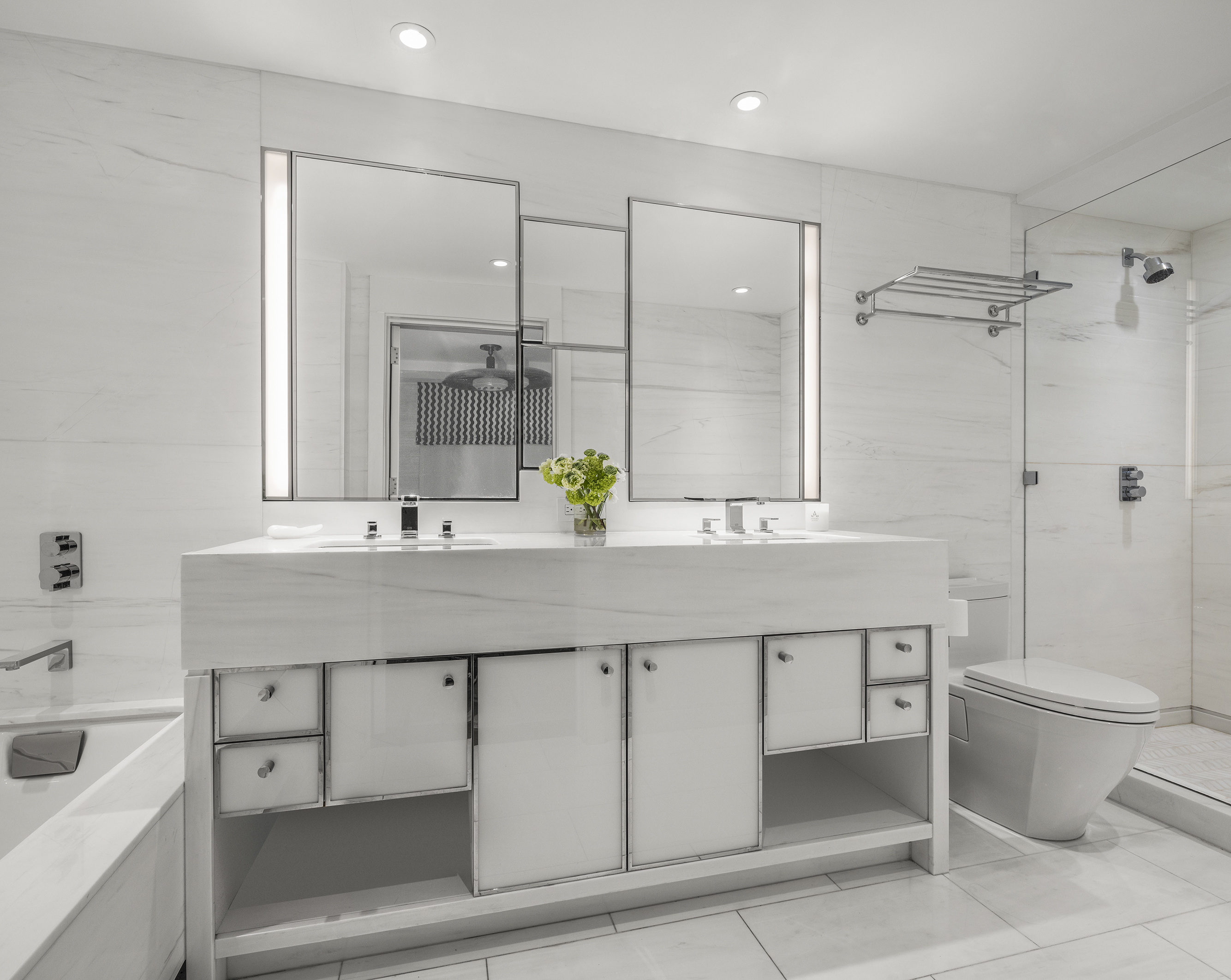 12 East 88th Street, Unit 8A Manhattan, NY 10128 - Photo 8 of 19 a bathroom with a double vanity sink toilet and shower