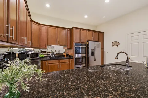 a kitchen with counter top space cabinets and appliances