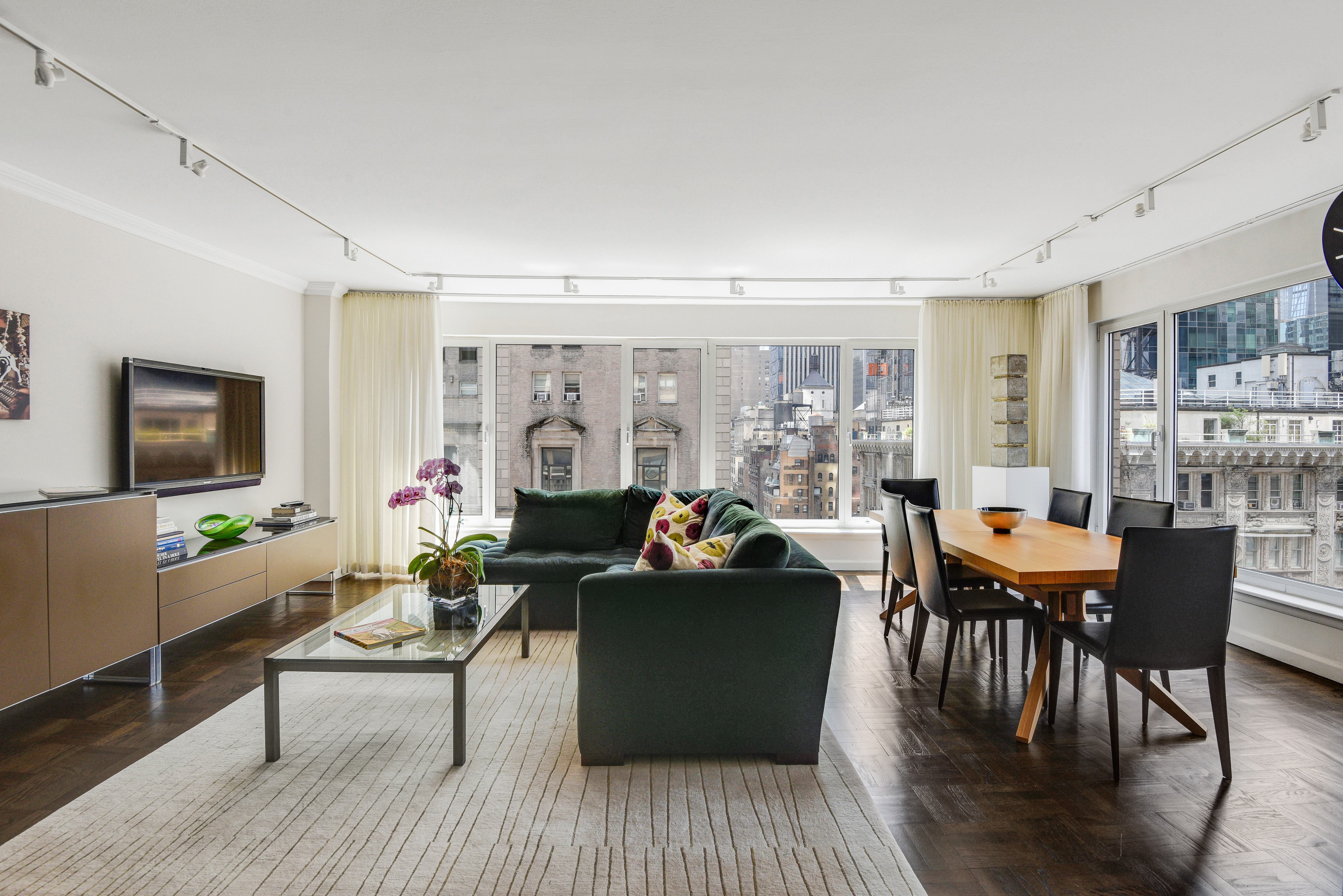 200 Central Park South, Unit 19J Manhattan, NY 10019 - Photo 5 of 12 a living room with furniture and a flat screen tv