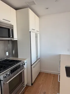 a stove top oven sitting inside of a kitchen