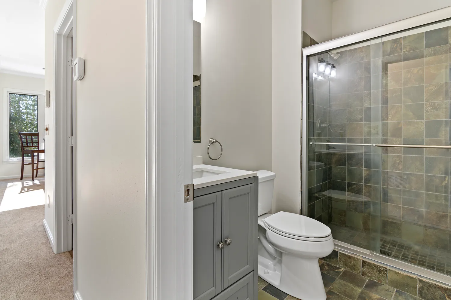 a bathroom with a toilet a sink and shower