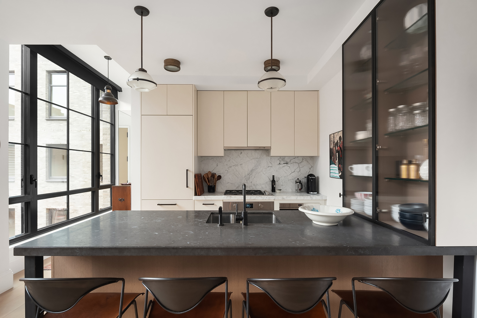 438 East 12th Street, Unit 6F Manhattan, NY 10009 - Photo 5 of 27 a kitchen with a table chairs and cabinets