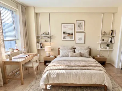 a bedroom with two beds and a table