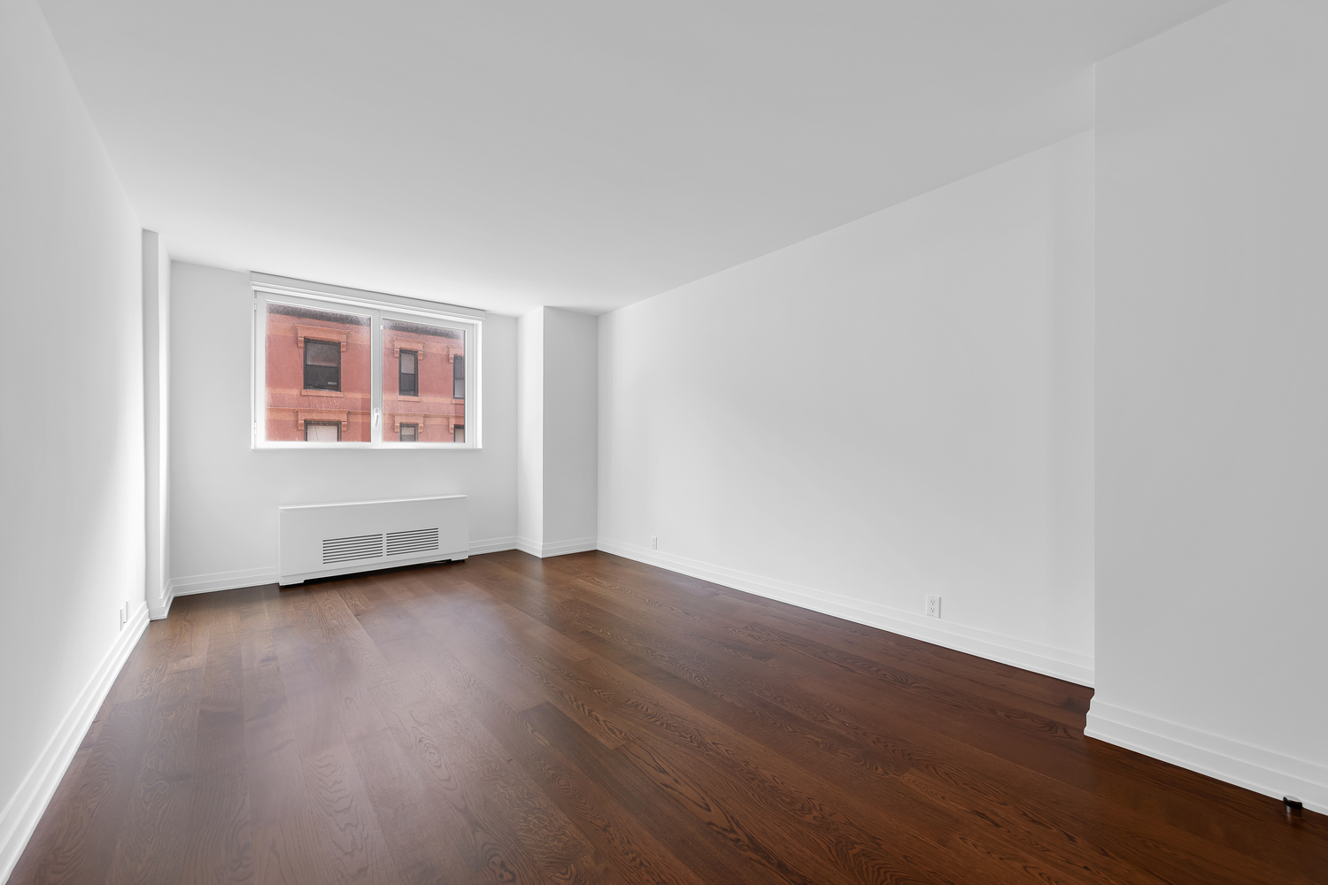 200 East 94th Street, Unit 315 Manhattan, NY 10128 - Photo 8 of 25 a view of an empty room with wooden floor and a window